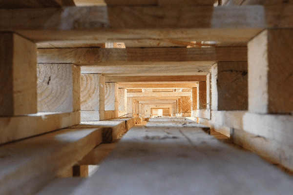 Image looking through a pile of well-stacked pallets