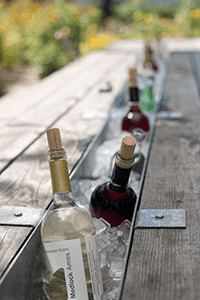 Pallet wine bottle cooler trough in a table