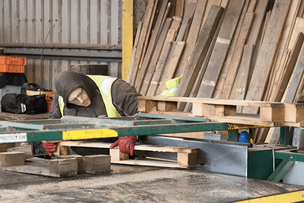 Universal Pallets expert repairing a wooden pallet