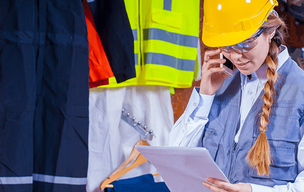 Warehouse worker checking schedule and calling suppliers