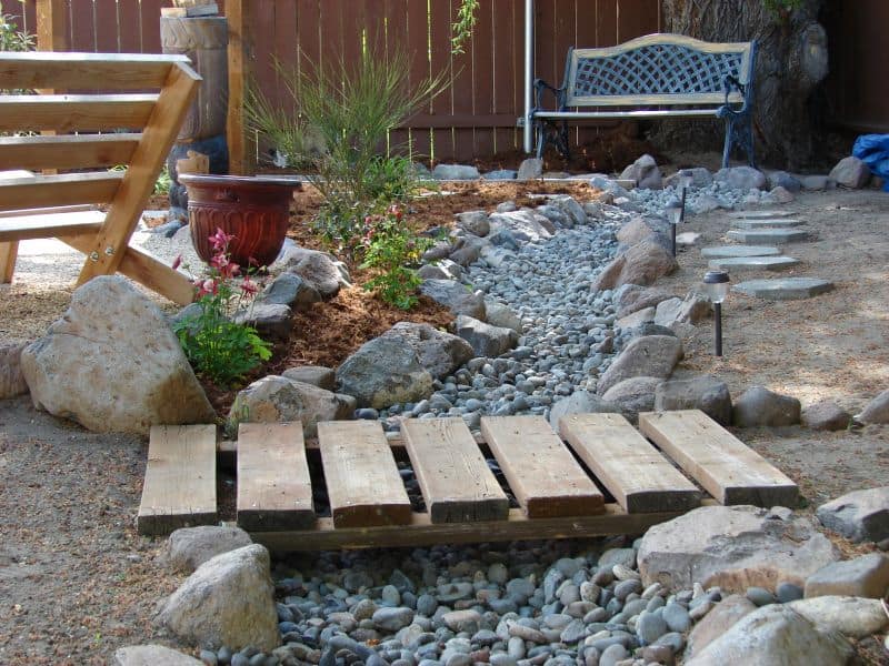 ornamental pallet bridge over a pebble stream