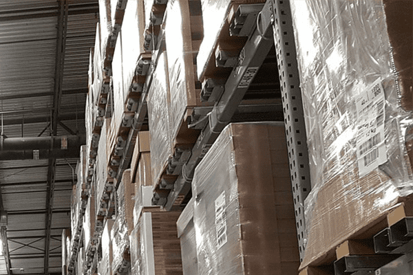 shrink wrapped goods on pallets in warehouse